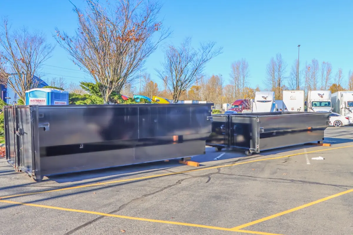 Professional dumpster rental service with roll-off container on residential driveway in Lake Monticello